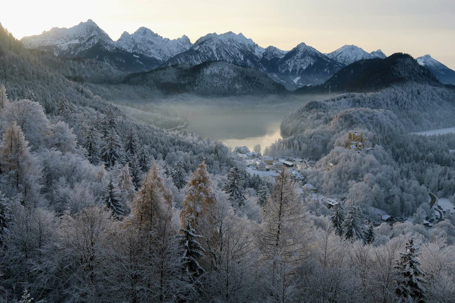 View from Neuschwanstein Castle of lake and mountains in the snow