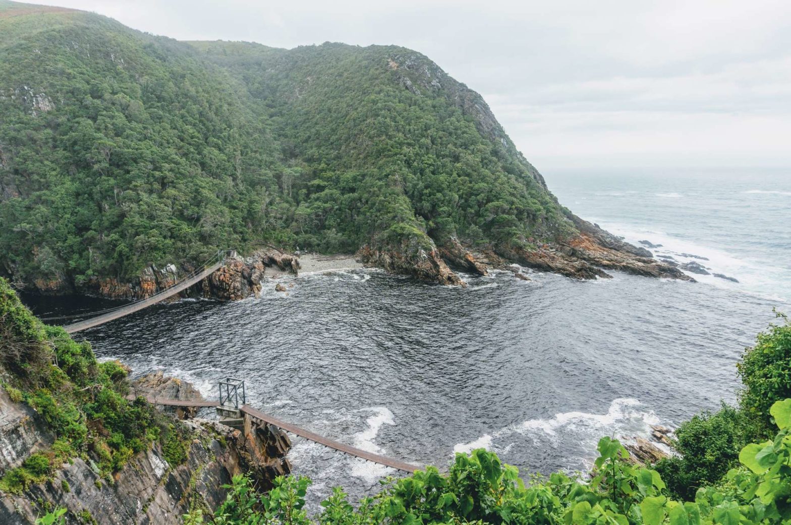 storms river mouth suspension bridge on the garden route in grey weather